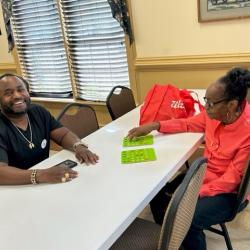 Two people playing bingo together at a table.